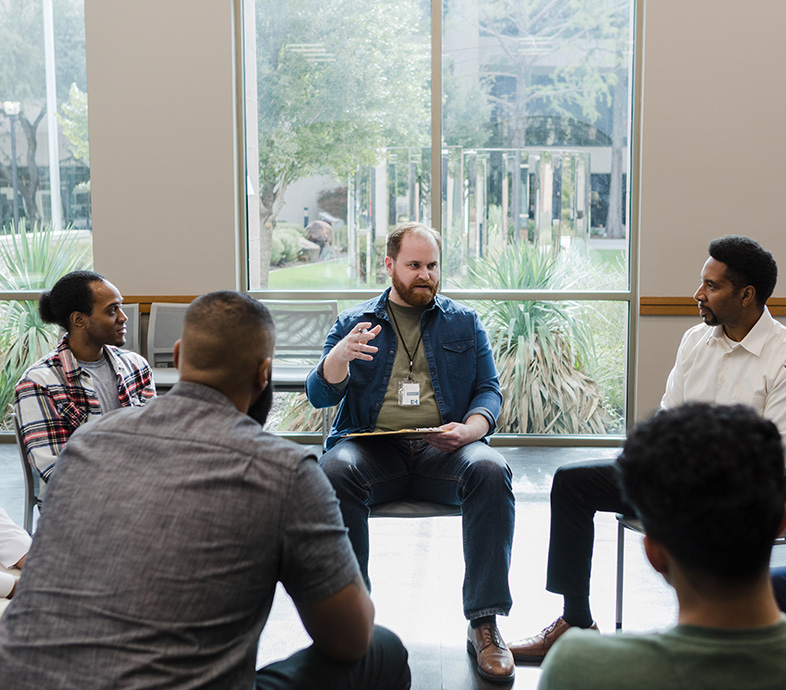 Male counseling leading group counseling with other men