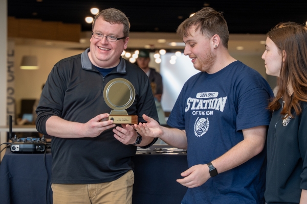 Jasen Sokol, Director of WJCU, and students with ISBC trophy