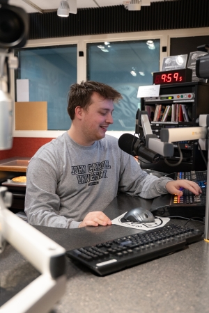 Zachary Sinutko in WJCU Radio Station office