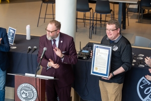 Mayor Michael Dylan Brennan of University Heights announcing "WJCU Station of the Year Day" 