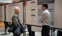 A student shares his research with a John Carroll professor 