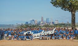 Students by Cleveland sign. 