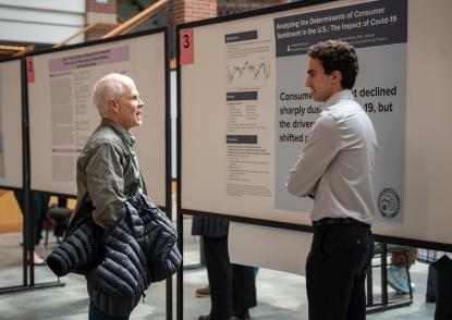 A student shares his research with a John Carroll professor 