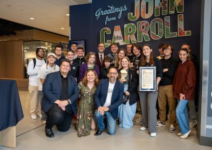 WJCU Radio Station team with trophy and ISBC representatives