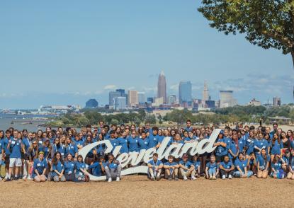 Students by Cleveland sign. 
